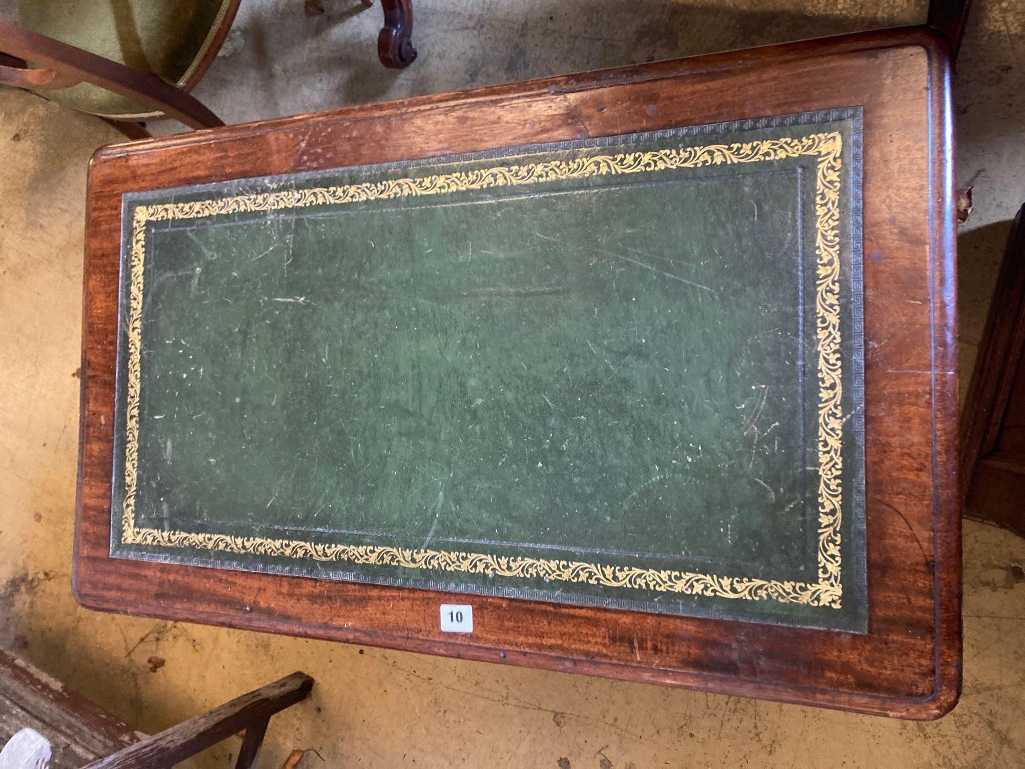 A late Victorian mahogany writing table, with leather lined top and ceramic castors, width 88cm